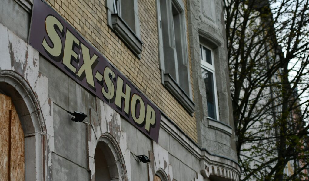 a sign that reads sex shop on the side of a building
