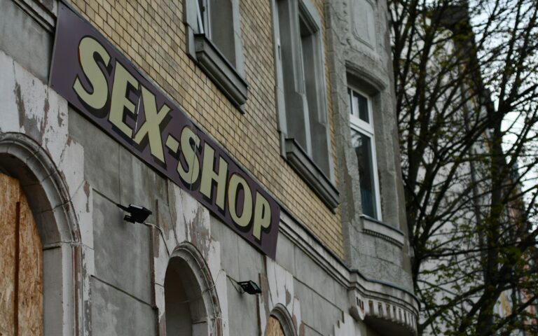 a sign that reads sex shop on the side of a building